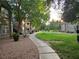 Scenic walkway through a landscaped common area with lush greenery and mature shade trees at 555 E Silverado Ranch Blvd # 2052, Las Vegas, NV 89183