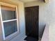 A decorative metal security door, welcome mat, and exterior window define the front entrance at 555 E Silverado Ranch Blvd # 2052, Las Vegas, NV 89183
