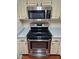 Close-up of the stainless steel oven and microwave, featuring modern design and functionality at 555 E Silverado Ranch Blvd # 2052, Las Vegas, NV 89183