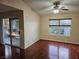 Living room featuring wood-look laminate floors, ceiling fan, window and sliding glass doors at 555 E Silverado Ranch Blvd # 2052, Las Vegas, NV 89183