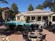 Community pool area featuring a fenced pool, lounge chairs, a BBQ grill, and comfortable seating at 555 E Silverado Ranch Blvd # 2052, Las Vegas, NV 89183