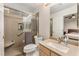Bathroom featuring a walk-in shower, vanity with sink, toilet, and a view into the bedroom at 56 Grossinger Ct, Henderson, NV 89074