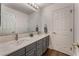 Well-lit bathroom featuring a double sink vanity with gray cabinetry and modern fixtures at 56 Grossinger Ct, Henderson, NV 89074