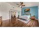 Bright bedroom featuring hardwood floors, a ceiling fan, and natural light from the window at 56 Grossinger Ct, Henderson, NV 89074