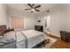 Comfortable bedroom with dark wood floors, neutral walls, a ceiling fan, and an attached bathroom at 56 Grossinger Ct, Henderson, NV 89074