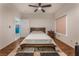 Bright bedroom with hardwood floors, ceiling fan, and an open door leading to another room at 56 Grossinger Ct, Henderson, NV 89074