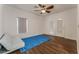 Spacious bonus room with hardwood floors, a ceiling fan, and a modern sofa at 56 Grossinger Ct, Henderson, NV 89074