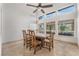 Bright dining area features vaulted ceilings, travertine floors and large windows at 56 Grossinger Ct, Henderson, NV 89074