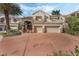 Attractive two-story home featuring a terracotta-colored driveway, a two-car garage and lush landscaping at 56 Grossinger Ct, Henderson, NV 89074