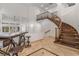Welcoming foyer boasts travertine flooring, a winding staircase and soaring ceilings creating an airy ambiance at 56 Grossinger Ct, Henderson, NV 89074