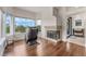 Bright living room with hardwood floors, a cozy fireplace, and scenic outdoor views at 56 Grossinger Ct, Henderson, NV 89074