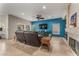 Spacious living room with tile floors, ceiling fan, fireplace, and large windows offering natural light at 56 Grossinger Ct, Henderson, NV 89074