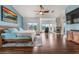 Large main bedroom offers wood floors, a ceiling fan, fireplace, and a sitting area by the windows at 56 Grossinger Ct, Henderson, NV 89074