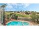 Beautiful pool and spa with views of the lush green golf course and blue skies at 56 Grossinger Ct, Henderson, NV 89074