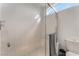 All-white tiled shower with glass enclosure and a view of the blue sky at 56 Grossinger Ct, Henderson, NV 89074
