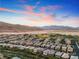 Stunning aerial view of the housing community with mountain views and desert landscape at sunset at 5662 Oak Bend Dr, Las Vegas, NV 89135