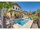 This backyard features a pool and jacuzzi, outdoor dining and a built in barbeque at 5662 Oak Bend Dr, Las Vegas, NV 89135