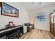 This bedroom features wood floors, a small couch, a keyboard and fun decor at 5662 Oak Bend Dr, Las Vegas, NV 89135