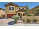Charming two-story home with a well-maintained front yard and a red garage door at 5662 Oak Bend Dr, Las Vegas, NV 89135
