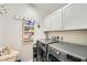 This laundry room features a front loading washer and dryer and plenty of storage at 5662 Oak Bend Dr, Las Vegas, NV 89135