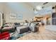 Open-concept living room featuring high ceilings and a large sectional sofa with lots of light at 5662 Oak Bend Dr, Las Vegas, NV 89135