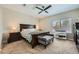 Spacious main bedroom features a dark wood king bed, ceiling fan, and neutral carpet at 5662 Oak Bend Dr, Las Vegas, NV 89135