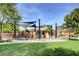 Community playground featuring play structures, slides, and shaded picnic area near green space at 5662 Oak Bend Dr, Las Vegas, NV 89135