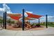 Community playground with multiple play structures, shaded by sail canopies at 5662 Oak Bend Dr, Las Vegas, NV 89135