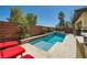 This backyard pool features a built in jacuzzi and well manicured landscaping at 5662 Oak Bend Dr, Las Vegas, NV 89135
