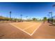 Community tennis court with well-kept playing surface, surrounded by landscaping at 5662 Oak Bend Dr, Las Vegas, NV 89135