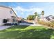 Sprawling backyard featuring a pool, lush synthetic grass, outdoor lounge, and a built-in basketball hoop at 5684 Benevento Ct, Las Vegas, NV 89141