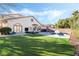 Large backyard with a pool, patio, and verdant synthetic lawn, perfect for outdoor enjoyment and relaxation at 5684 Benevento Ct, Las Vegas, NV 89141