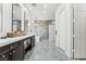 The updated bathroom features double sinks, marble countertops, and modern fixtures at 5684 Benevento Ct, Las Vegas, NV 89141