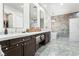 The updated bathroom features double sinks, marble countertops, and a luxurious soaking tub at 5684 Benevento Ct, Las Vegas, NV 89141