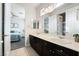 Bathroom featuring double sinks, a large mirror, and access to the bedroom and shower room at 5684 Benevento Ct, Las Vegas, NV 89141