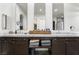 This renovated bathroom features double sinks, marble countertops, and modern lighting at 5684 Benevento Ct, Las Vegas, NV 89141