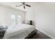Cozy bedroom featuring a modern bed frame, ceiling fan, and shuttered windows at 5684 Benevento Ct, Las Vegas, NV 89141