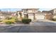 Charming two-story home with a well-manicured front yard and a three car attached garage at 5684 Benevento Ct, Las Vegas, NV 89141