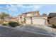 Inviting two-story home with a three-car garage, balcony, and well-kept landscaping, set in a desirable location at 5684 Benevento Ct, Las Vegas, NV 89141