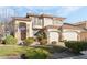 Beautiful two-story home featuring a balcony, complemented by lush landscaping and a welcoming entrance at 5684 Benevento Ct, Las Vegas, NV 89141