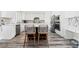 Bright kitchen features white cabinetry, a center island with bar seating, stainless steel appliances, and stylish backsplash at 5684 Benevento Ct, Las Vegas, NV 89141