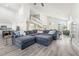 Expansive living room with high ceilings, open staircase, and a modern sectional sofa, great for gatherings at 5684 Benevento Ct, Las Vegas, NV 89141