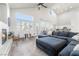 Bright living room features vaulted ceilings, a fireplace, large windows, and a comfortable sectional sofa at 5684 Benevento Ct, Las Vegas, NV 89141