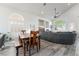 Open concept living area featuring modern furnishings, a dining table, and plenty of natural light from large windows at 5684 Benevento Ct, Las Vegas, NV 89141