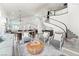 Bright, open living room with high ceilings, modern decor, and a staircase enhancing the inviting atmosphere at 5684 Benevento Ct, Las Vegas, NV 89141