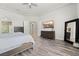 Comfortable main bedroom features wood-look floors, neutral walls, and en-suite bath access at 5684 Benevento Ct, Las Vegas, NV 89141