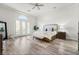 Serene main bedroom with tray ceilings, French doors, ample natural light, and a neutral color palette at 5684 Benevento Ct, Las Vegas, NV 89141
