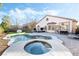 Inviting backyard pool and spa area featuring beautiful tile work, with an outdoor dining set at 5684 Benevento Ct, Las Vegas, NV 89141