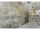 The renovated shower features marble tile, a rainfall shower head, and modern fixtures at 5684 Benevento Ct, Las Vegas, NV 89141