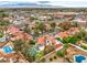 Expansive aerial view of a residential area featuring homes with terracotta roofs and private swimming pools at 5757 Charles Holden Ct, Las Vegas, NV 89103